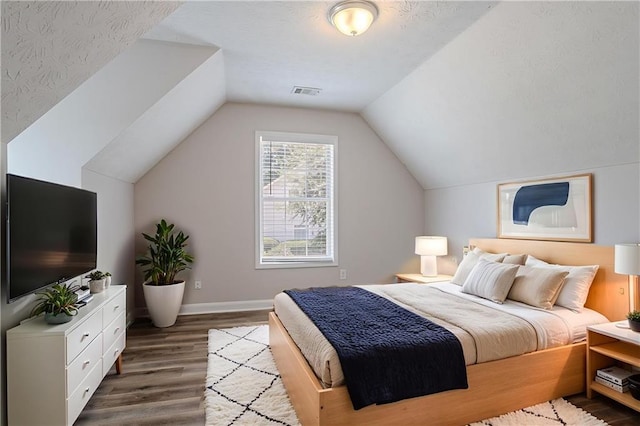 1797 Emerson Lake Cir, Snellville, GA 30078 - bedroom with dark wood-style flooring and vaulted ceiling