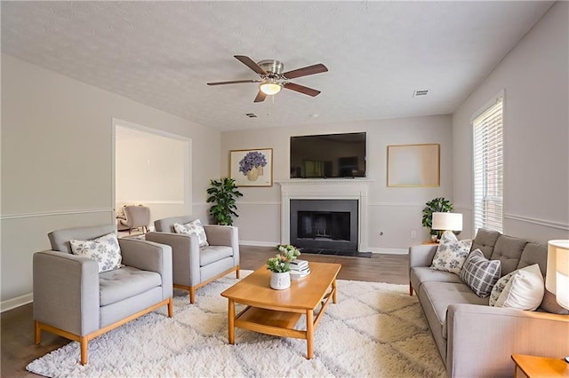 1797 Emerson Lake Cir, Snellville, GA 30078 - living area with wood finished floors, ceiling fan, and a fireplace with flush hearth