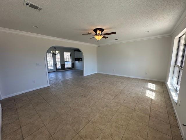 unfurnished room with a textured ceiling, ceiling fan with notable chandelier, and ornamental molding