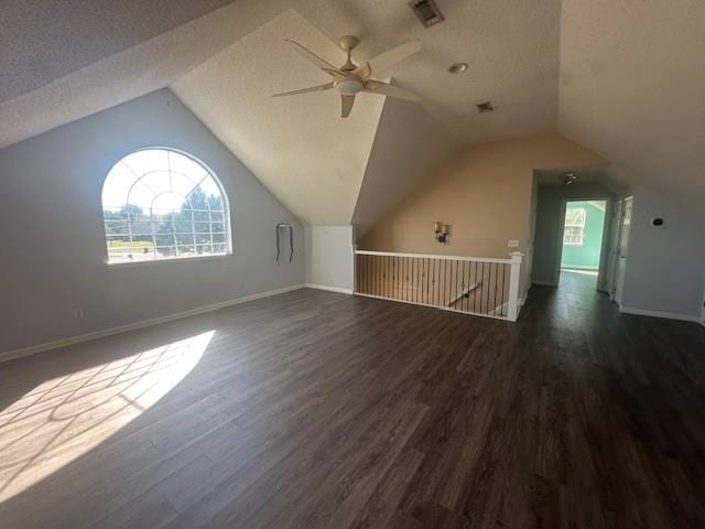 additional living space featuring ceiling fan, dark hardwood / wood-style flooring, and vaulted ceiling