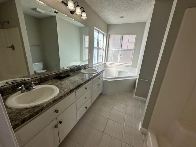 full bathroom featuring tile patterned floors, vanity, a textured ceiling, plus walk in shower, and toilet