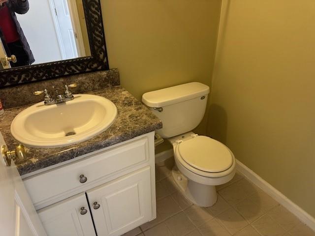 bathroom featuring tile patterned flooring, vanity, and toilet