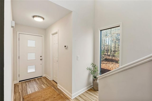 foyer featuring light wood-type flooring and baseboards