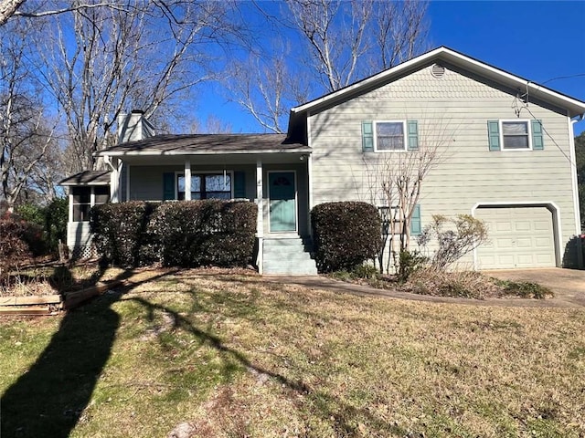 split level home featuring a front yard and a garage