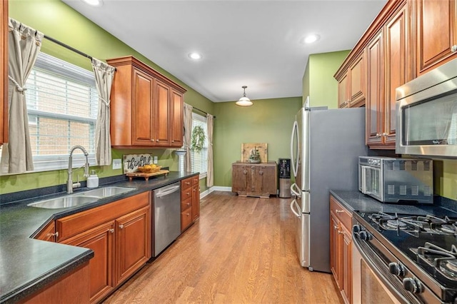930 Brenau Point Dr, Gainesville, GA 30501 - kitchen featuring appliances with stainless steel finishes, a sink, dark countertops, light wood finished floors, and recessed lighting