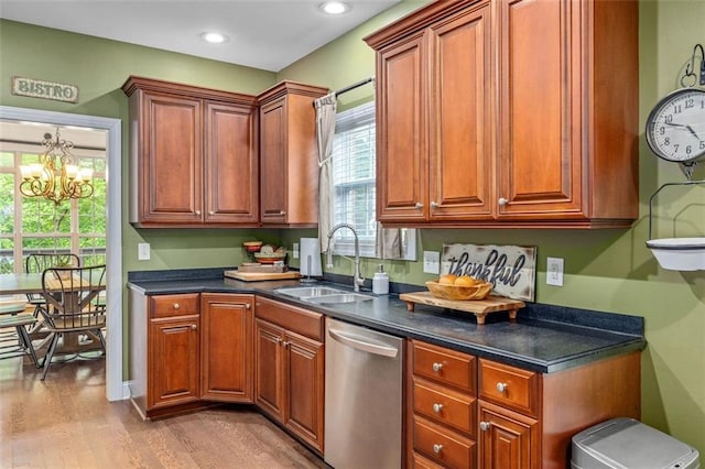 930 Brenau Point Dr, Gainesville, GA 30501 - kitchen featuring stainless steel dishwasher, a sink, light wood-style floors, dark countertops, and a chandelier