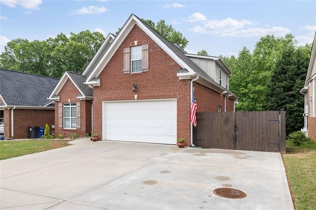 930 Brenau Point Dr, Gainesville, GA 30501 - traditional-style house featuring brick siding, an attached garage, driveway, and fence