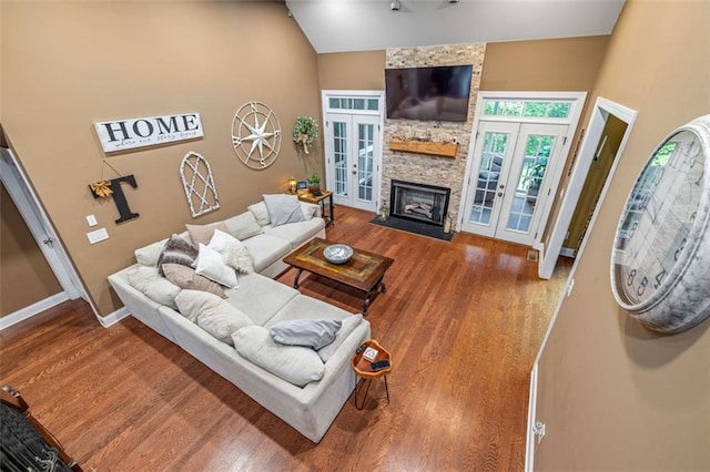 930 Brenau Point Dr, Gainesville, GA 30501 - living room with french doors, wood finished floors, high vaulted ceiling, a fireplace, and baseboards