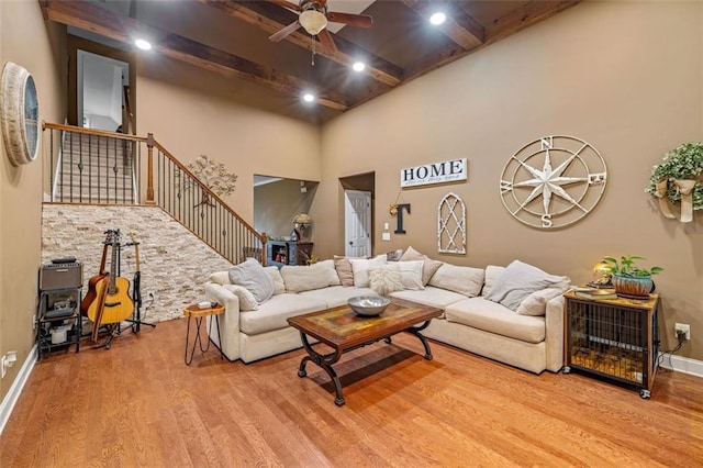 930 Brenau Point Dr, Gainesville, GA 30501 - living area featuring wood finished floors, ceiling fan, stairs, beam ceiling, and a high ceiling