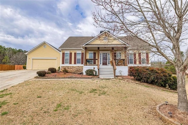 view of front facade with a garage, a porch, and a front yard