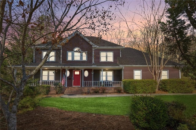 view of front of property with a porch and a front yard