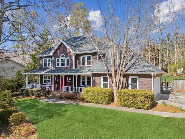 colonial inspired home featuring driveway, an attached garage, covered porch, and a front yard