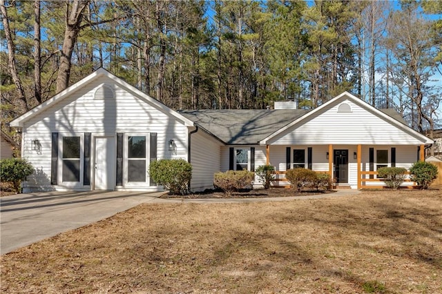 ranch-style house with a front lawn and covered porch