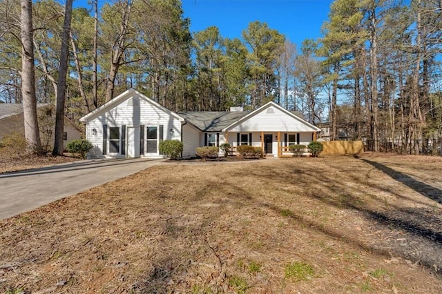 ranch-style house with a front lawn and a porch