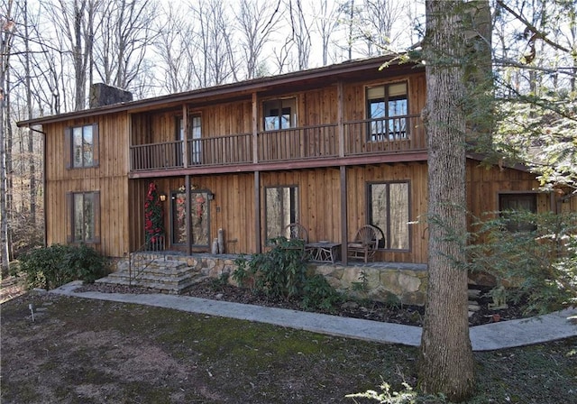 rear view of property featuring a balcony