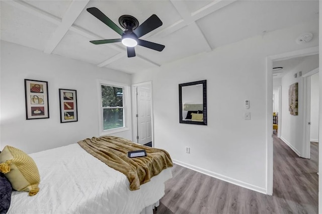 bedroom with beamed ceiling, ceiling fan, coffered ceiling, and light hardwood / wood-style floors