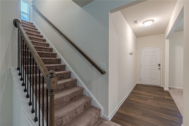 staircase featuring hardwood / wood-style floors