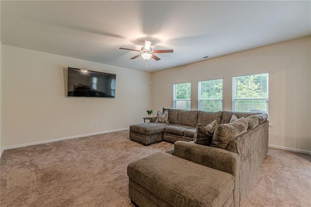 carpeted living room featuring ceiling fan