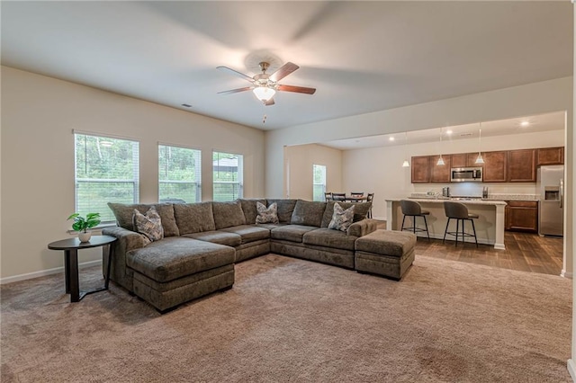 living room with light colored carpet and ceiling fan