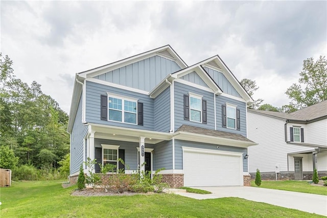 craftsman inspired home featuring a porch, a front yard, and a garage