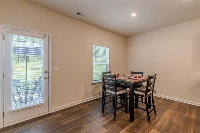 dining room featuring plenty of natural light and dark hardwood / wood-style floors