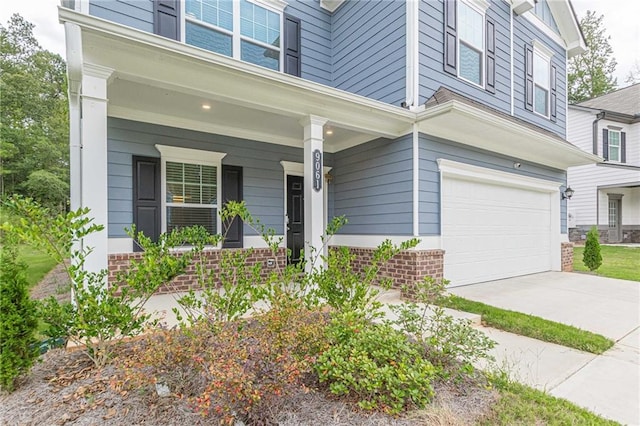 view of front of home with a garage and a porch