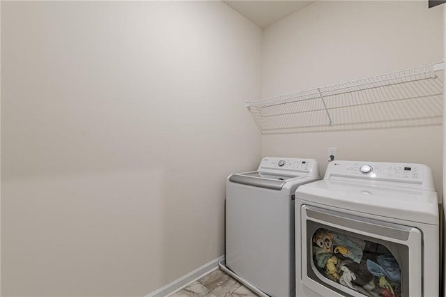 washroom featuring washer and clothes dryer