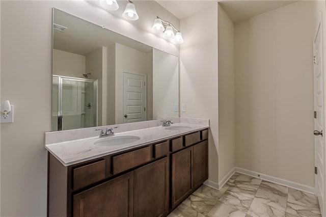 bathroom with a shower with door and vanity