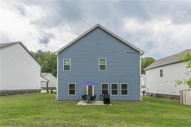 back of property with cooling unit, a patio, and a yard