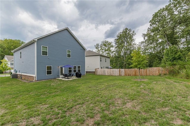 rear view of property featuring a yard and a patio