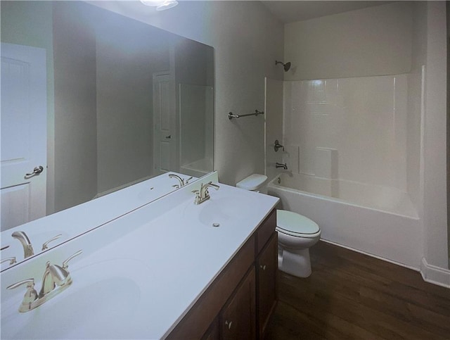 full bathroom featuring vanity, hardwood / wood-style flooring, toilet, and shower / bath combination