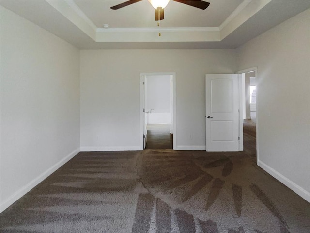 carpeted empty room featuring ornamental molding, a raised ceiling, and ceiling fan