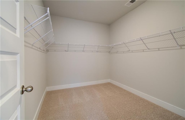 walk in closet with visible vents and carpet flooring