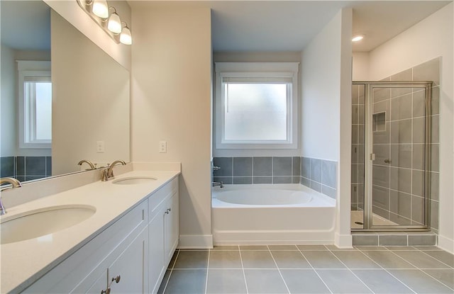 full bath with tile patterned floors, a wealth of natural light, and a sink