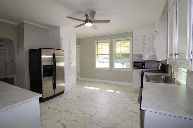 200 Litchfield St, Rockmart, GA 30153 - kitchen featuring stainless steel appliances, ceiling fan, white cabinets, light marble finish flooring, and ornamental molding