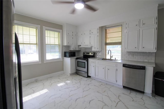 200 Litchfield St, Rockmart, GA 30153 - kitchen with appliances with stainless steel finishes, ceiling fan, tasteful backsplash, light countertops, and white cabinets