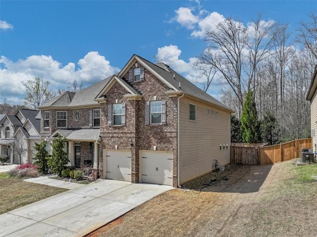 craftsman house with central AC unit, a garage, and a front lawn