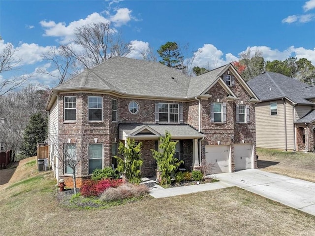 view of front of property with a garage, central AC unit, and a front lawn