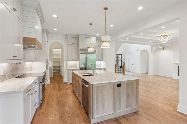 7188 Williams Rd, Flowery Branch, GA 30542 - kitchen with arched walkways, premium appliances, a sink, tasteful backsplash, and recessed lighting