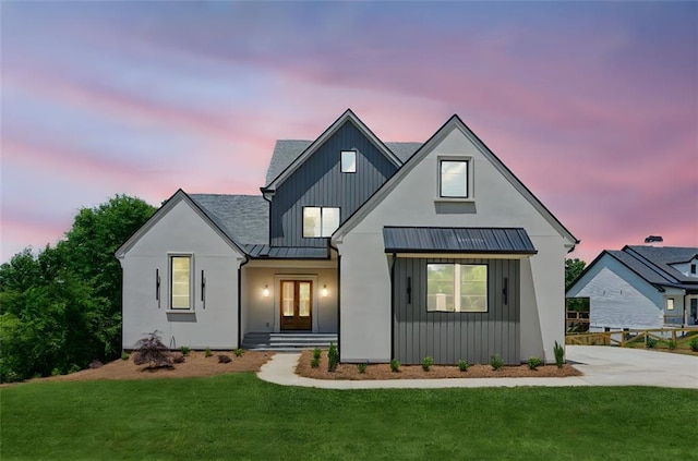 7188 Williams Rd, Flowery Branch, GA 30542 - modern farmhouse style home featuring a standing seam roof, a lawn, and metal roof