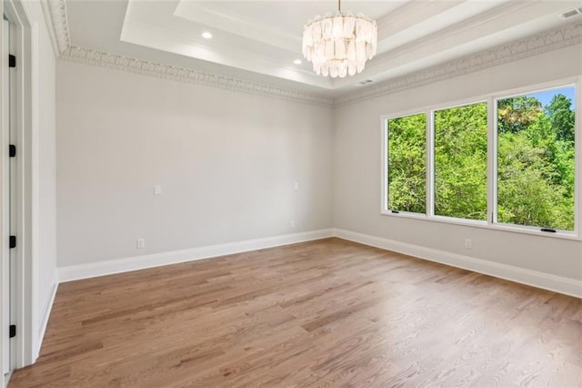 7188 Williams Rd, Flowery Branch, GA 30542 - unfurnished room with a tray ceiling, healthy amount of natural light, a chandelier, wood finished floors, and recessed lighting