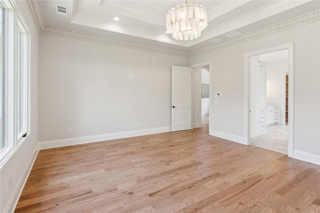 7188 Williams Rd, Flowery Branch, GA 30542 - unfurnished room featuring a tray ceiling, a chandelier, light wood-type flooring, ornamental molding, and baseboards