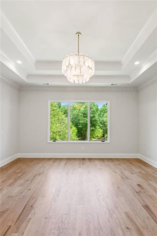7188 Williams Rd, Flowery Branch, GA 30542 - unfurnished room with a raised ceiling, crown molding, wood finished floors, a chandelier, and baseboards