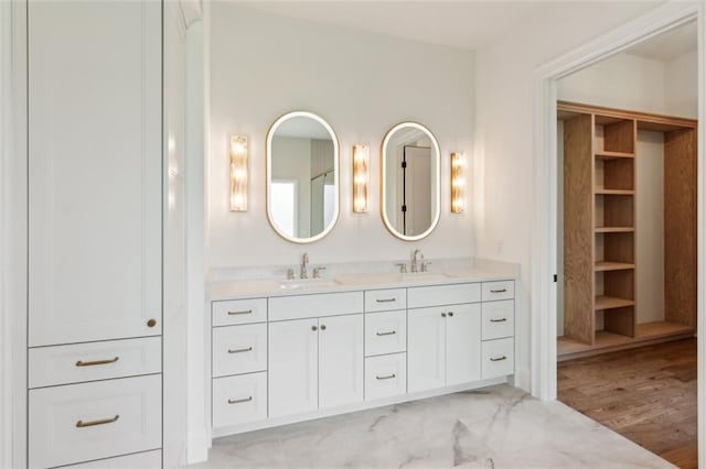 7188 Williams Rd, Flowery Branch, GA 30542 - bathroom featuring double vanity and a closet
