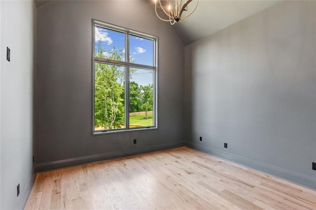 7188 Williams Rd, Flowery Branch, GA 30542 - empty room featuring a chandelier, light wood finished floors, vaulted ceiling, and baseboards