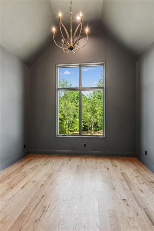 7188 Williams Rd, Flowery Branch, GA 30542 - additional living space featuring vaulted ceiling, a chandelier, and wood finished floors