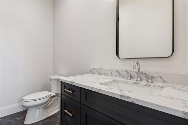 7188 Williams Rd, Flowery Branch, GA 30542 - bathroom featuring vanity, toilet, baseboards, and marble finish floors
