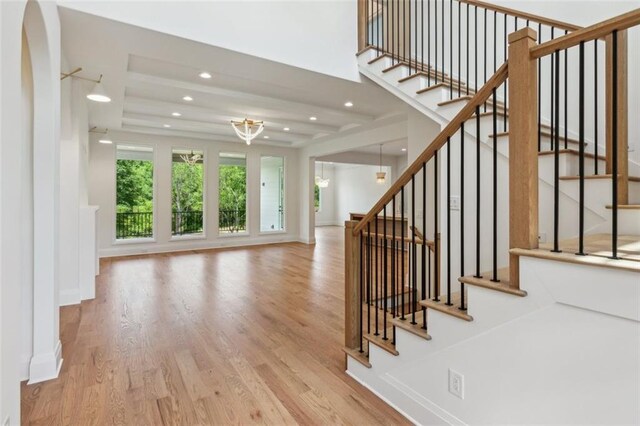 7188 Williams Rd, Flowery Branch, GA 30542 - staircase featuring wood finished floors, recessed lighting, a chandelier, arched walkways, and baseboards