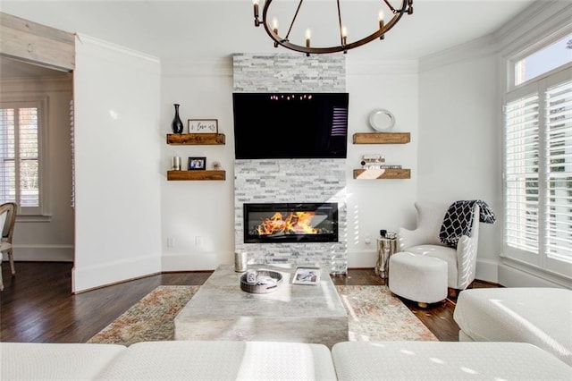 living room featuring a fireplace, ornamental molding, and dark wood-type flooring