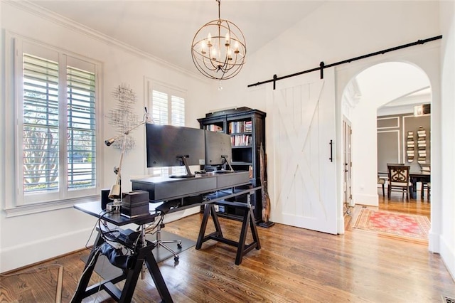 home office featuring baseboards, arched walkways, ornamental molding, wood finished floors, and a notable chandelier